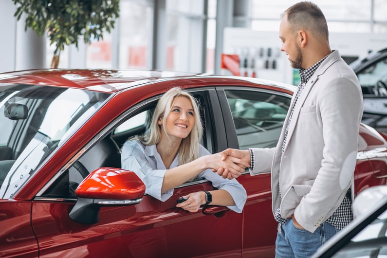 woman-sitting-car-receiving-keys